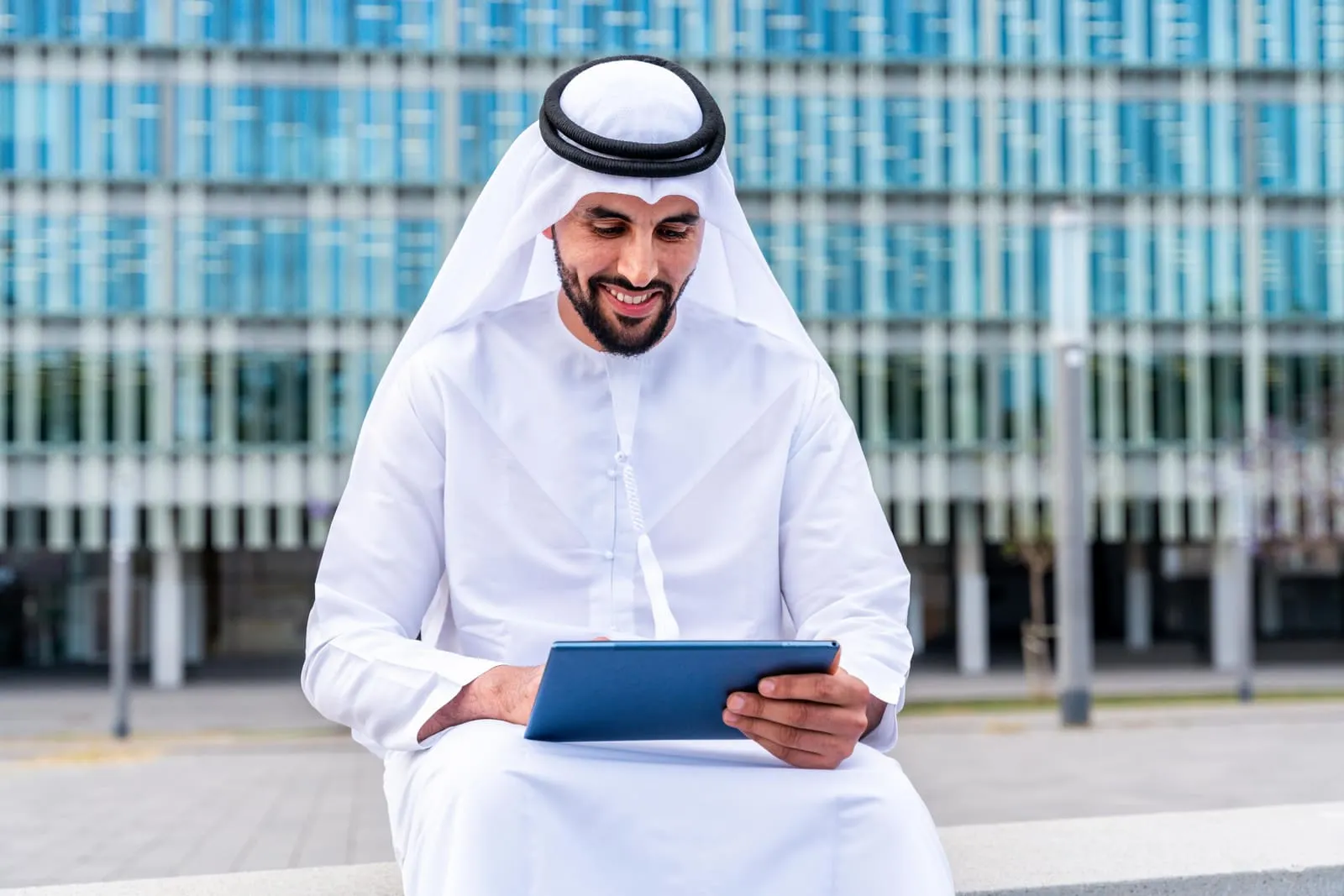 Saudi business professional reviewing certification documents